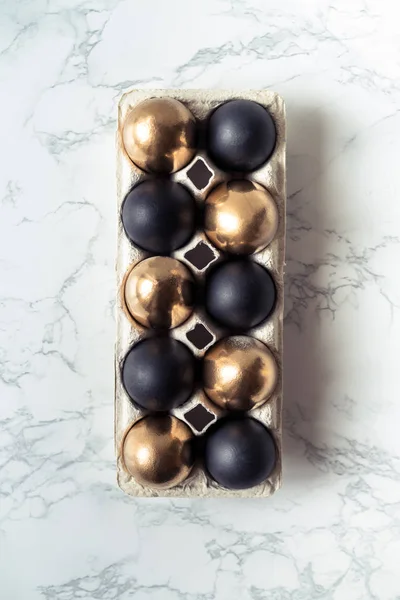 Пасхальные украшения в стиле минимализма с золотыми и черными яйцами — стоковое фото