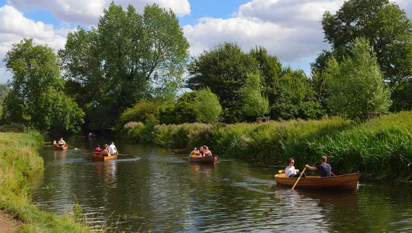 people rowing boats on the river stour on the essex