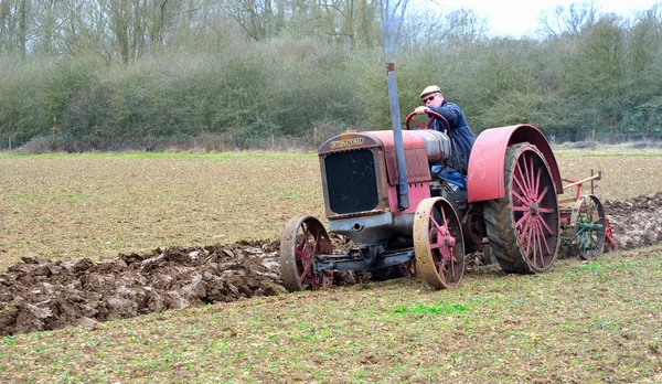 Vintage red International 1930's  tractor ploughing field. — Stock Photo, Image