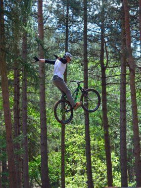 Haynes, Bedfordshire, İngiltere - 14 Mayıs 2017: Freestyle Stunt bisikletçi orta hava çok yüksek ağaçlar arka planda ile. 