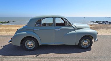 FELIXSTOWE, SUFFOLK, ENGLAND -  MAY 06, 2018: Classic Grey  Morris Oxford Motor Car Parked on Seafront Promenade. clipart