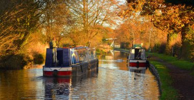 Wrenbury, Cheshire, İngiltere - 30 Kasım 2013: Llangollen kanalında dar botlar, Wrenbry botları ve sonbaharda yansımaları