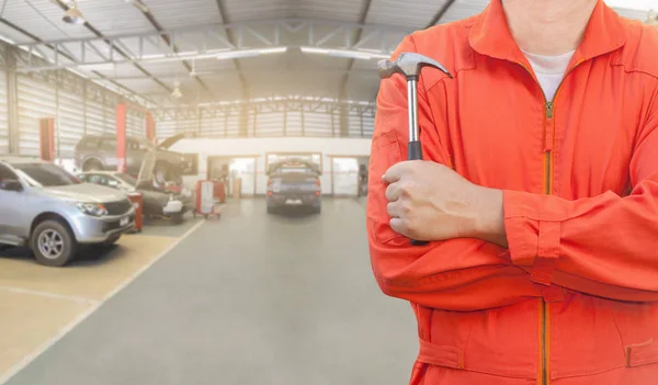 Meccanico che tiene un martello in garage — Foto Stock