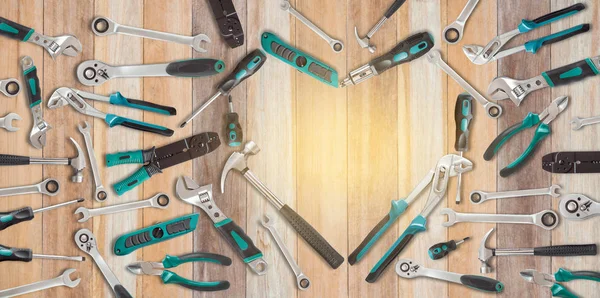 Heart shaped of service tools on wooden table with Warm light