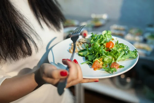 Femme garde assiette avec salade ; — Photo