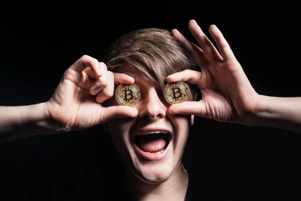 crazy bitcoin lover with golden coin by eyes;