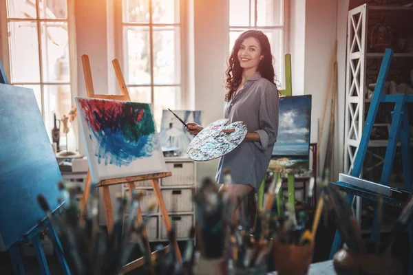 Mulher artista pintar com escovas e tintura de óleo — Fotografia de Stock