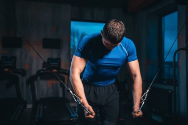 young athlete has physical workout with barbell in modern gym