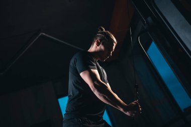 young athlete has physical workout with barbell in modern gym