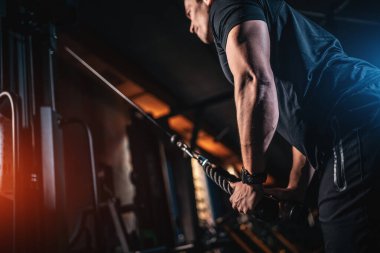 young athlete has physical workout with barbell in modern gym