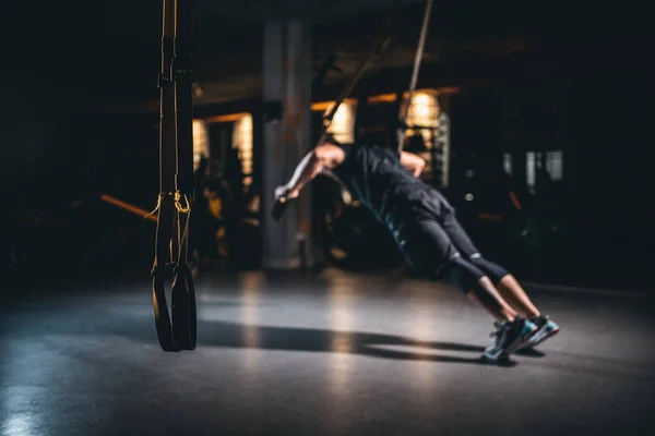Young man has crossfit workout with trx in modern gym — Stok fotoğraf
