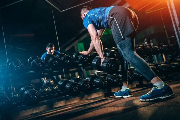 Young athlete has physical workout with barbell in modern gym — Stock Fotó