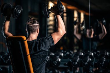 young athlete has physical workout with barbell in modern gym