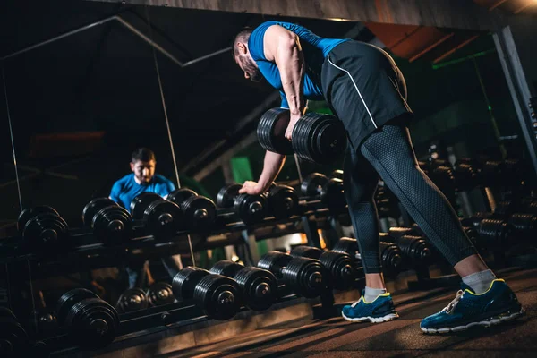 Young athlete has physical workout with barbell in modern gym — Stock Fotó