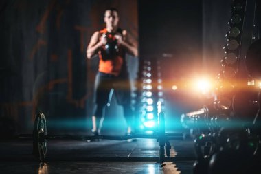 young athlete has physical workout with barbell in modern gym
