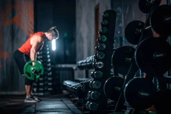 Young athlete has physical workout with barbell in modern gym — Stock Photo, Image