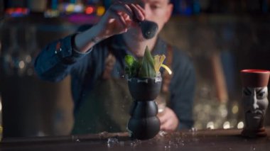 Kahveci likör ve meyve suyuyla egzotik kokteyl hazırlıyor.