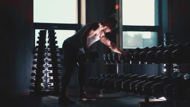 Athletic man with perfect torso exercising with dumbbells in gym — 비디오