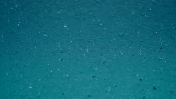 Gotas de agua de lluvia tropical caen en el lago azul claro o piscina — Vídeo de stock
