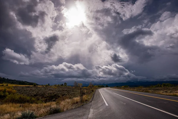 Asfalt yol ve çok bulutlu gökyüzü. ABD'de bir yere