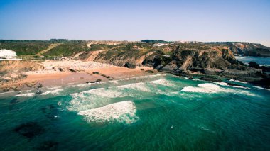 People rest on the beach naer Zambujeira de Mar, Portugal aerial view clipart