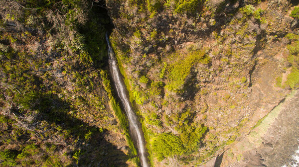 aerial view of waterfall and ocean in Madeira island