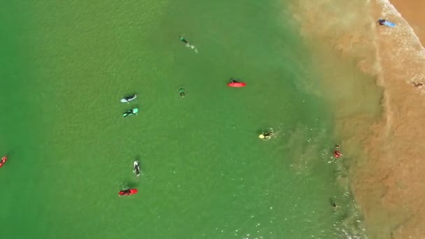 Group surfing lesson on Costa Caparica beautiful ocean beach, Portugal. Aerial view — Stock Video