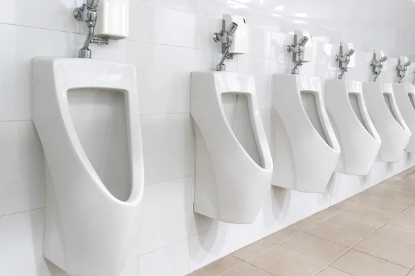 Modern restroom interior with urinal row — Stock Photo, Image