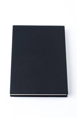 beyaz arkaplanda siyah defter.