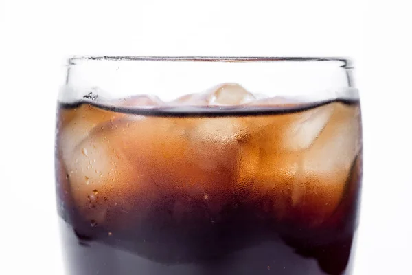 Ice cola with splashing, bubbles. Drink with ice.