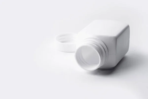 Белая пластиковая бутылка лекарства на белом фоне — стоковое фото