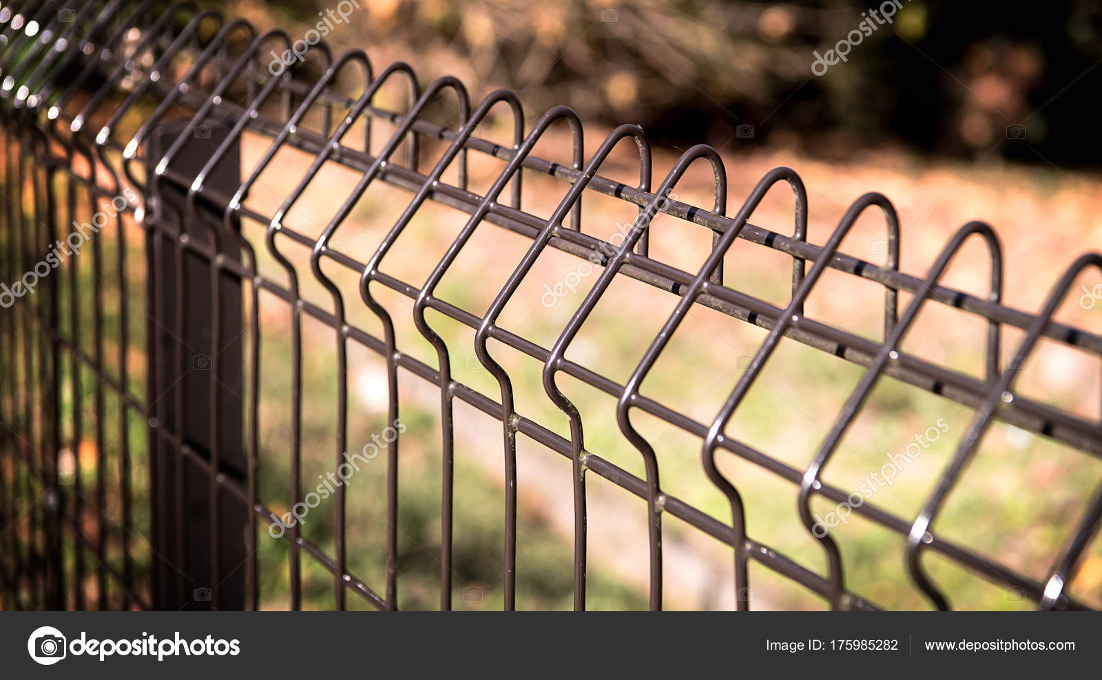 Steel grating fence of soccer field,Metal fence wire with grass Stock