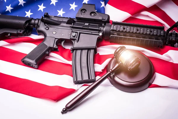 Gavel with gun on background of USA flag. — Stock Photo, Image