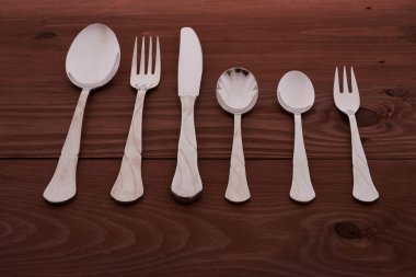 ahşap bir masa üzerinde çatal bıçak seti