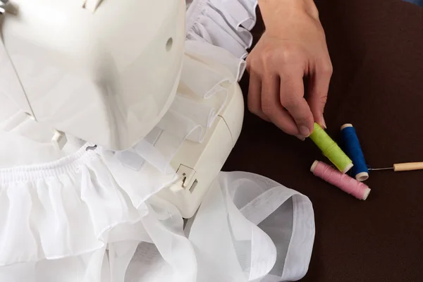 Young woman sewing fabric — Stock Photo, Image