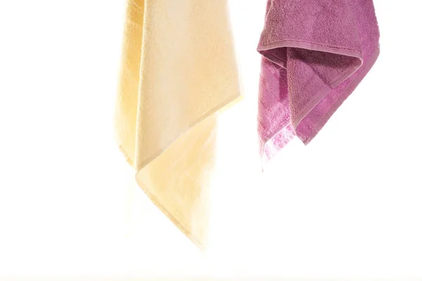 Towels hanging on a white background — Stock Photo, Image