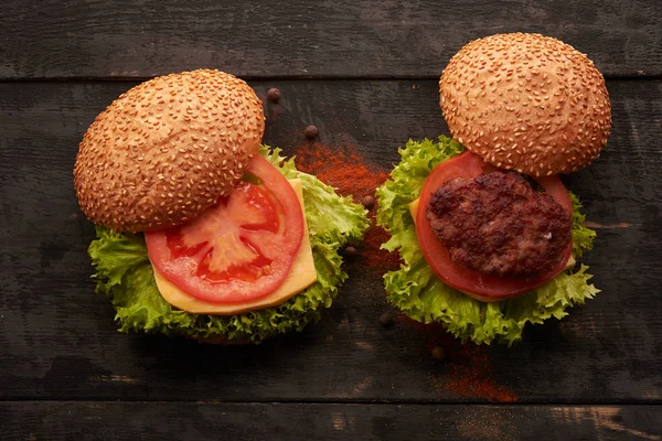 Two hamburger on a wooden table — Stock Photo, Image