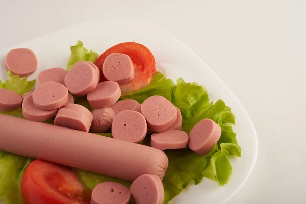 Sausages with vegetables on a white background — Stock Photo, Image