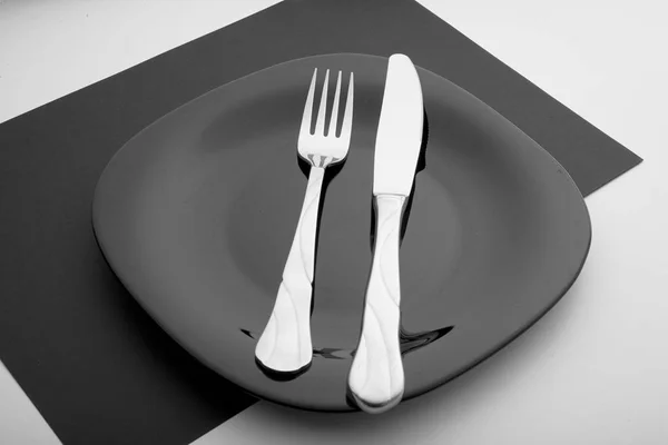 Knife, fork and plate on a white background — Stock Photo, Image