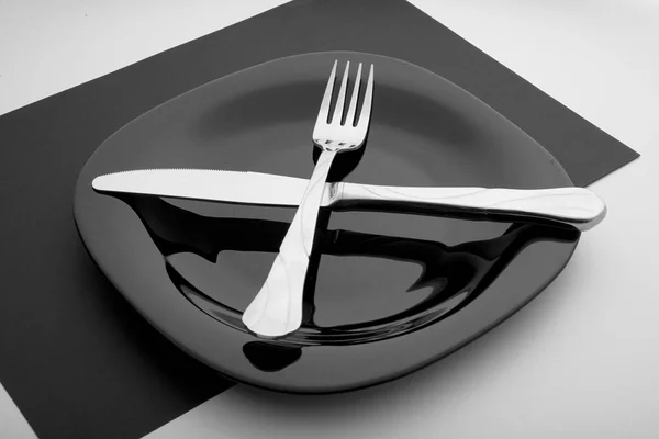 Knife, fork and plate on a white background — Stock Photo, Image