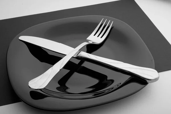 Knife, fork and plate on a white background — Stock Photo, Image