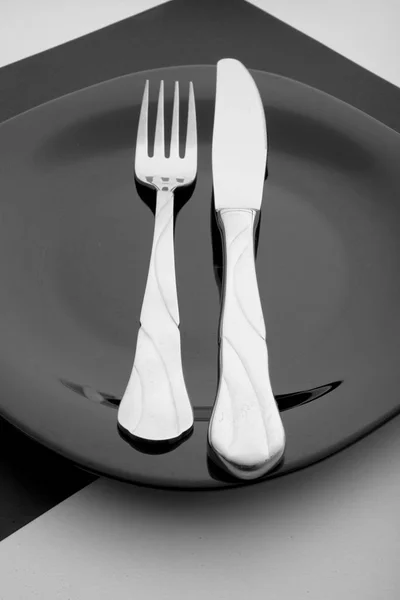 Cuchillo, tenedor y plato sobre fondo blanco —  Fotos de Stock