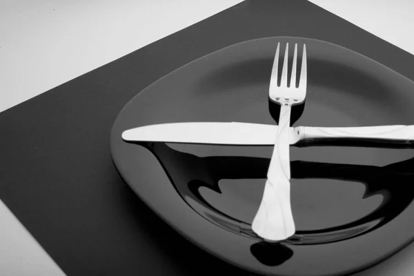 Knife, fork and plate on a white background — Stock Photo, Image