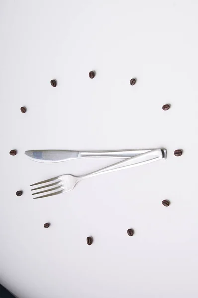 Clock with fork and knife on white background — Stock Photo, Image