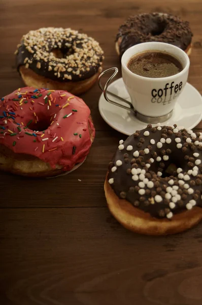 Donuts and coffee on a wooden table — Stock Photo, Image