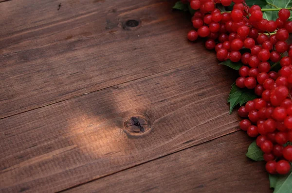 Red viburnum on a wooden table — Stock Photo, Image