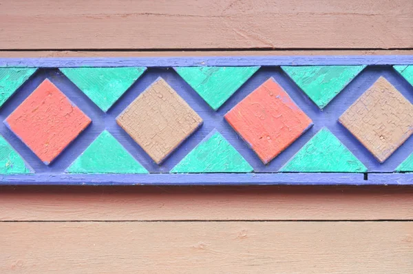 Ornamento de color sobre tablas de madera — Foto de Stock