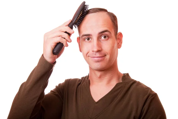 Young man combing the hair of a white background — Stock Photo, Image
