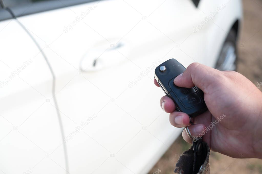 Man hand unlock a car by car remote
