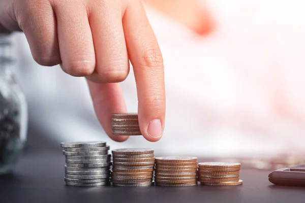 Female hand stack coins to shown concept of growing business and wealthy